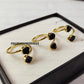 Gold-plated, adjustable rings featuring raw black tourmaline gemstones. The rings showcase the natural, unpolished texture of the black tourmaline crystals. These unique, handmade gemstone rings are ideal as protection jewelry, unique gifts for women, or a statement piece for bohemian, spiritual, or earthy styles. The black tourmaline offers grounding and protective energies. These electroplated raw black tourmaline rings are perfect for those seeking a raw crystal and metaphysical benefits.